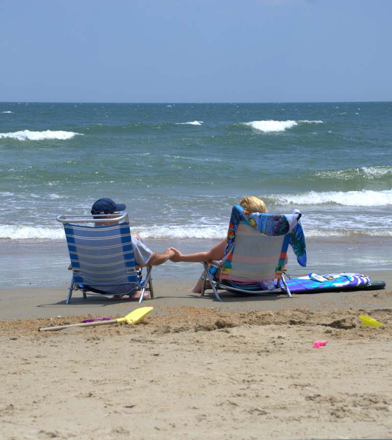 Couple on beach holding hands