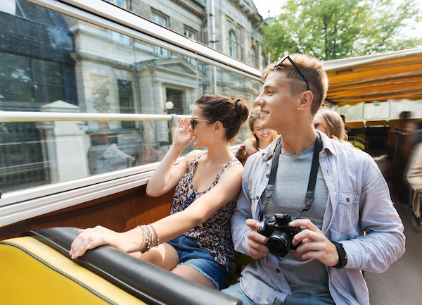 smiling couple on a tour bus