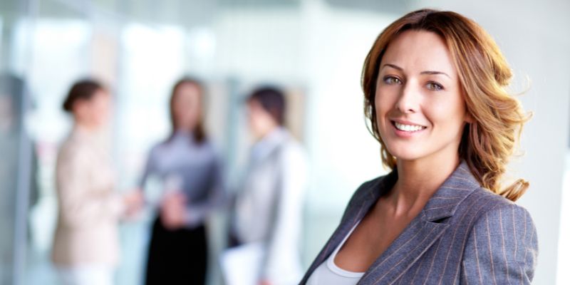 We were made for this: Female executive smiling